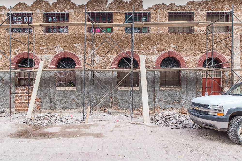 The application of a new layer of plaster and paint to a colonial building front appears to be serious business. The application of a new layer of plaster and paint to a colonial building front appears to be serious business.